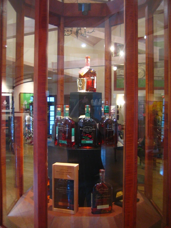 a display area for bottles of alcohol through glass doors