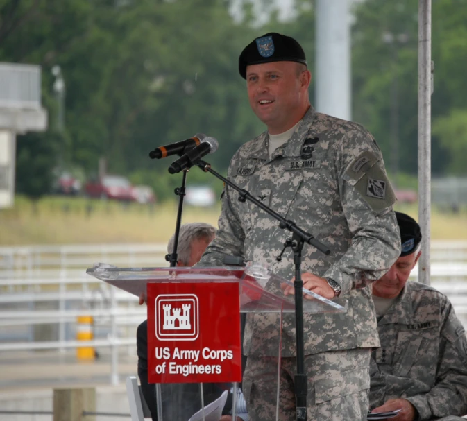 an air force man in uniform speaking at an airport