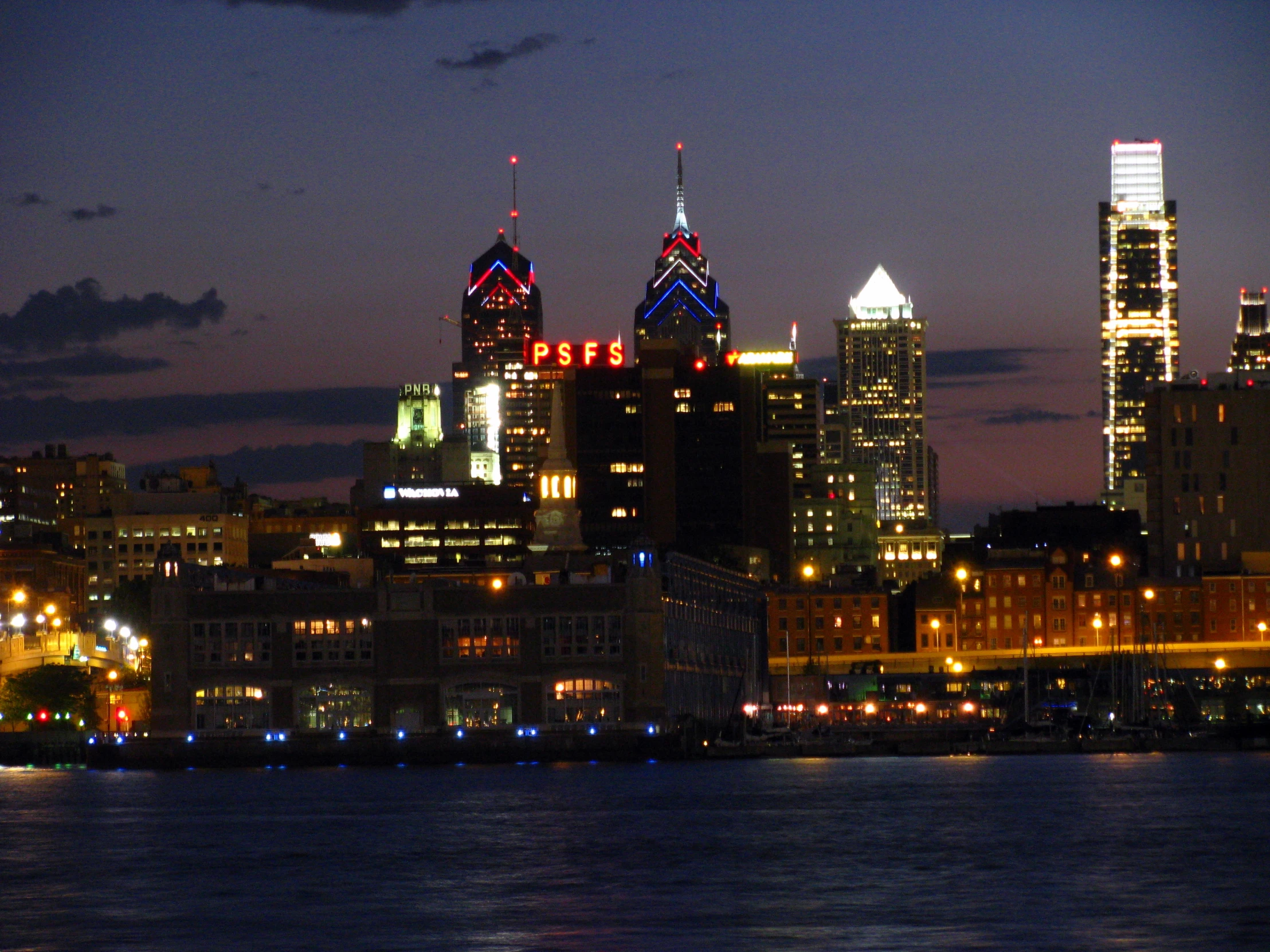 the lights of city buildings shine brightly at night