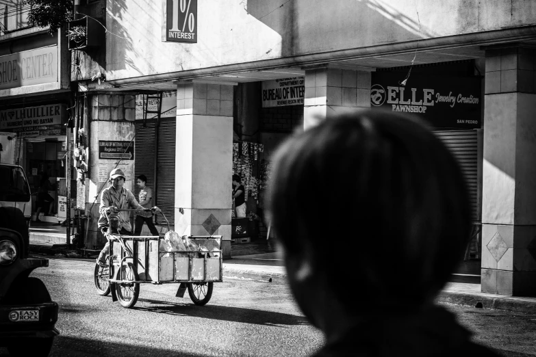 an image of woman in the street riding her bicycle