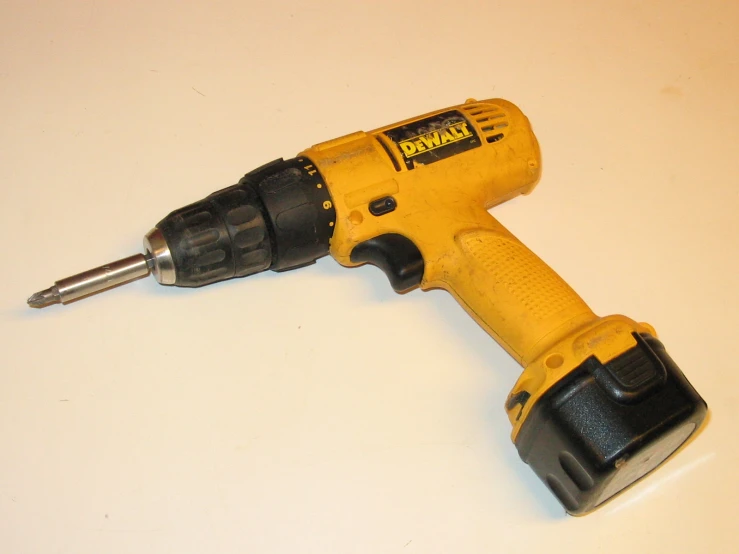 a power drill laying on a table top