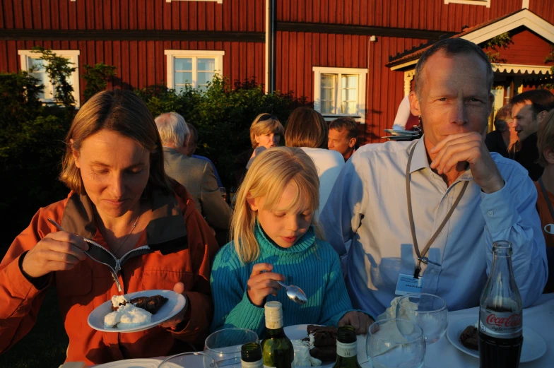 a man eating a small piece of cake at a table