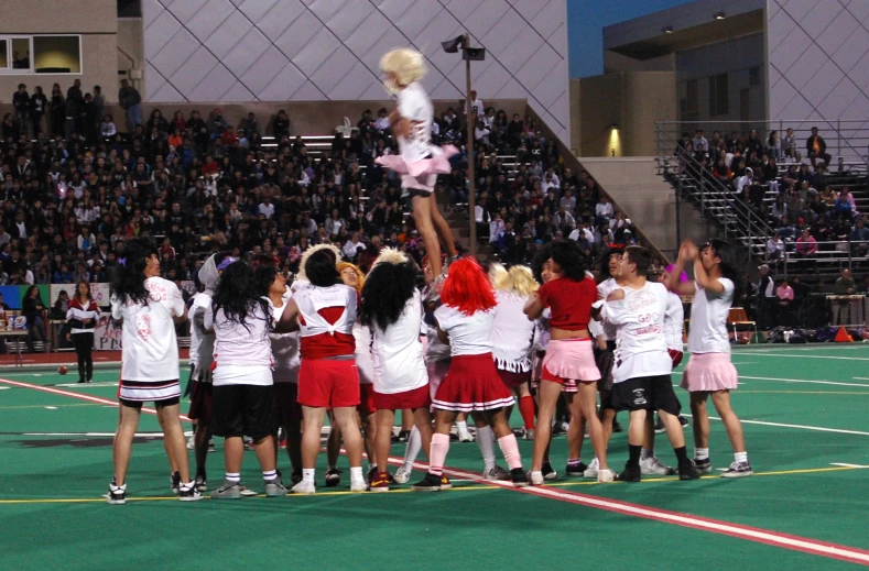 a bunch of girls are playing in front of an audience