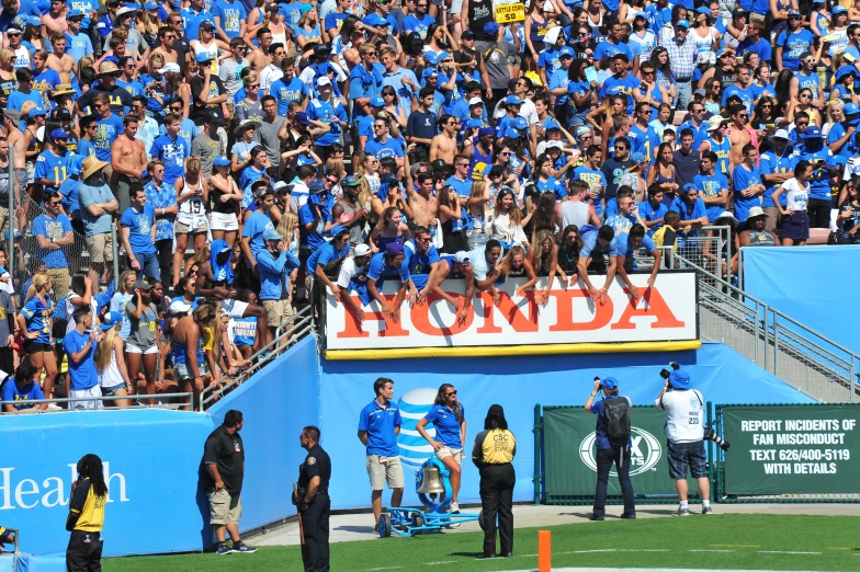 many people are standing on a sideline watching soing