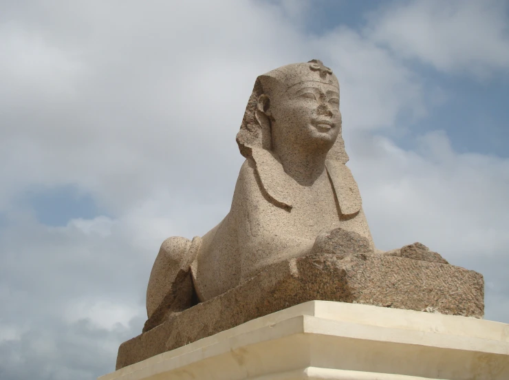 the large stone statue has a long black beard