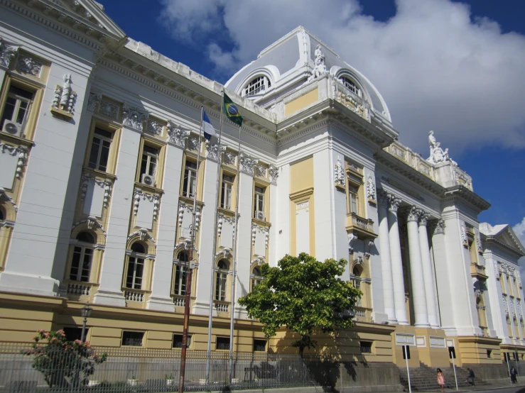 an ornate white building with large columns against a blue sky