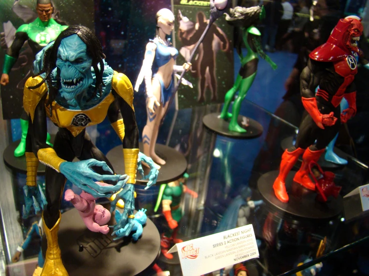 a collection of action toys displayed in a display case