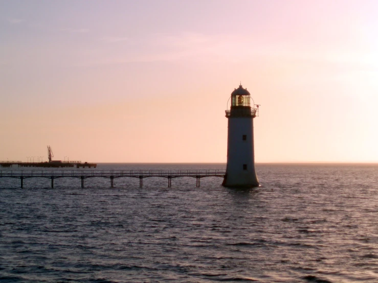 a light house sits in the middle of the water