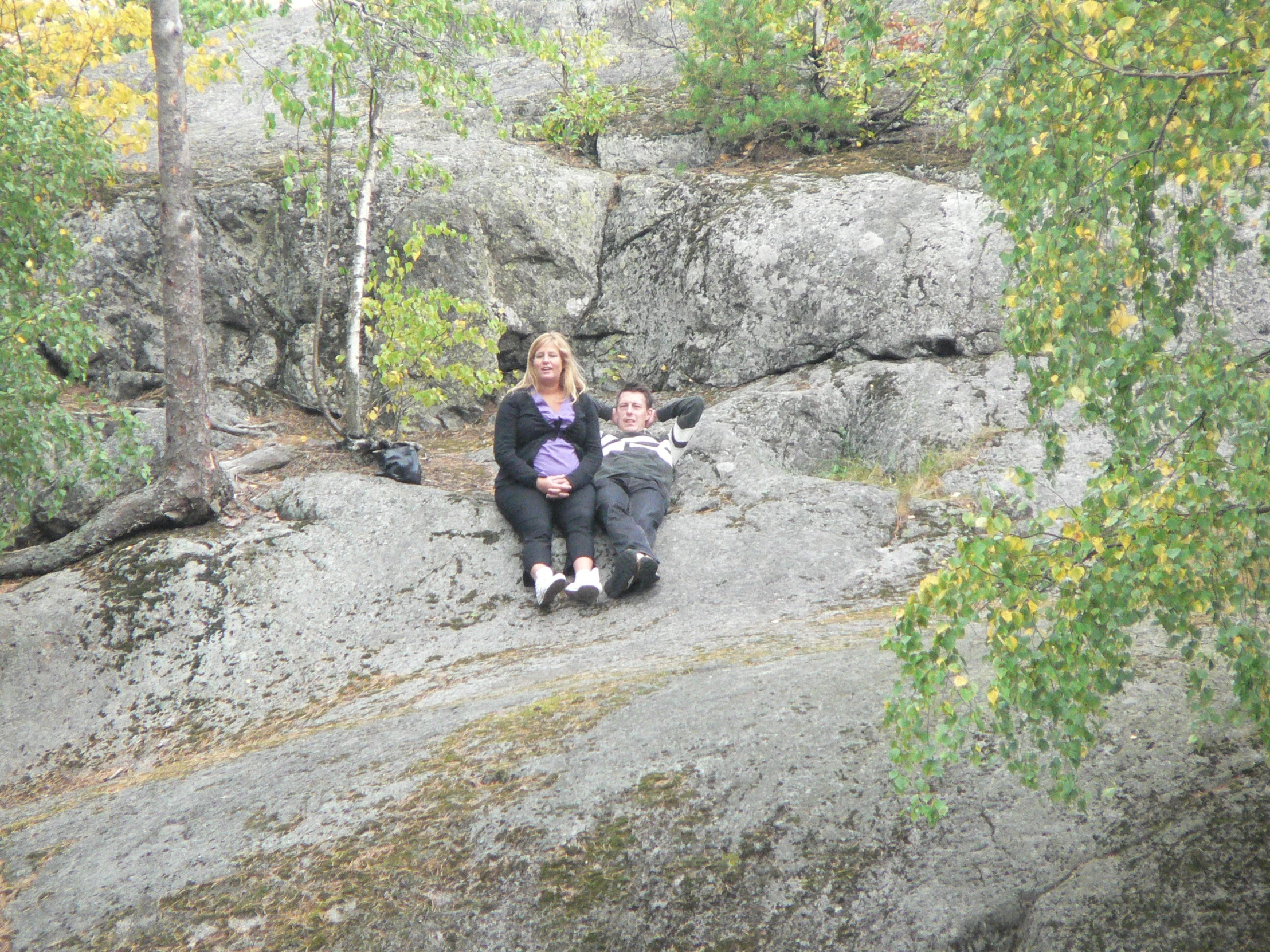 a group of people sitting on the rocks