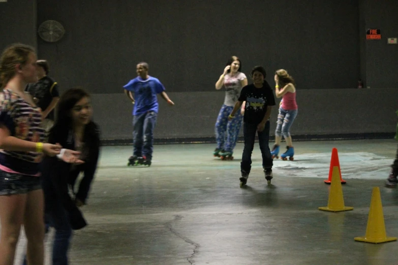 the girls are skateboarding in a gym