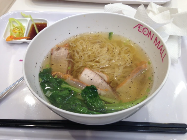 a bowl of noodle soup with chopsticks is displayed