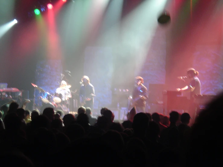 people on a stage with lights from brightly colored lights