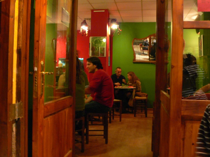 several people in the restaurant are sitting at tables