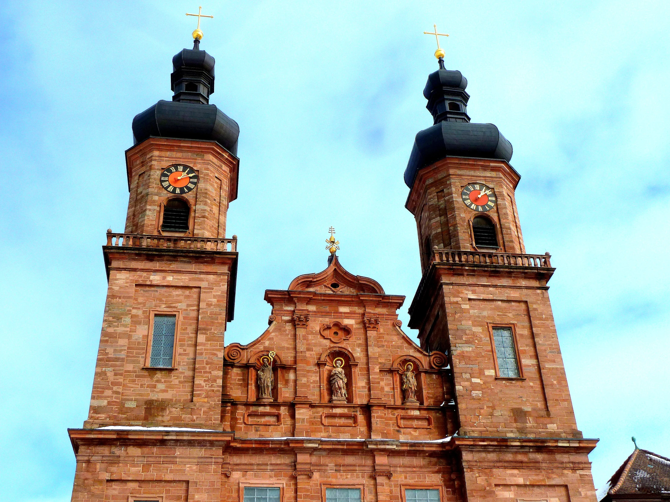 the roof of a building with a tower with two bells