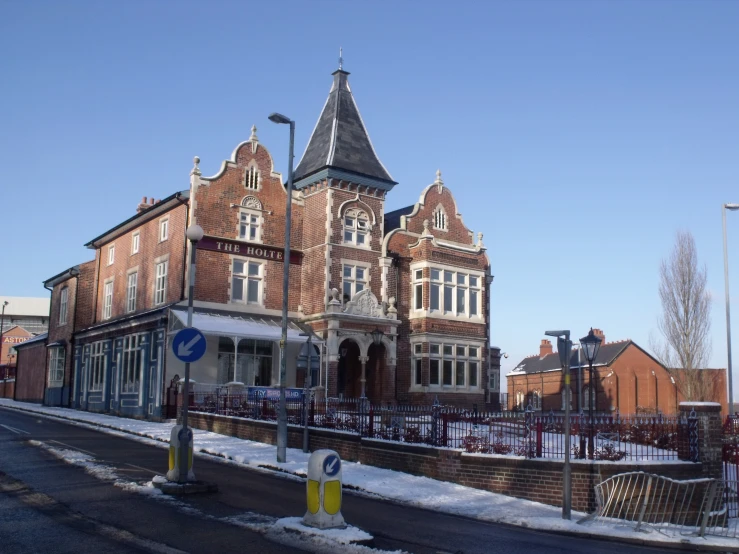 this red brick building is on the corner of a street