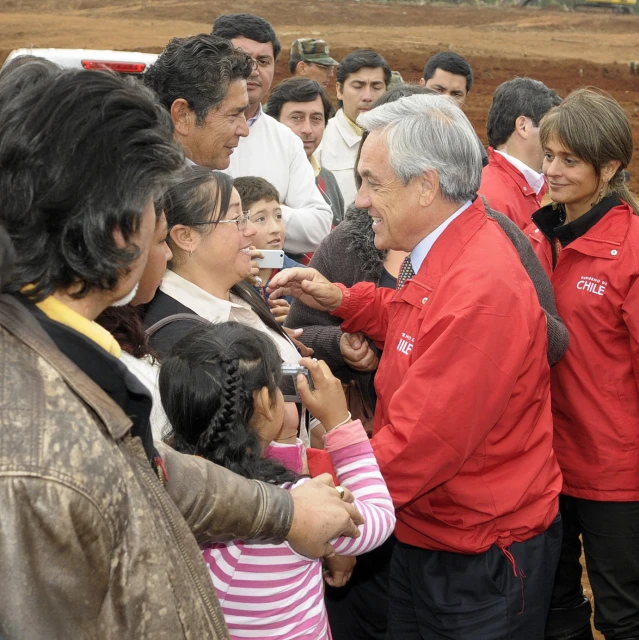 a group of people holding hands and looking at each other