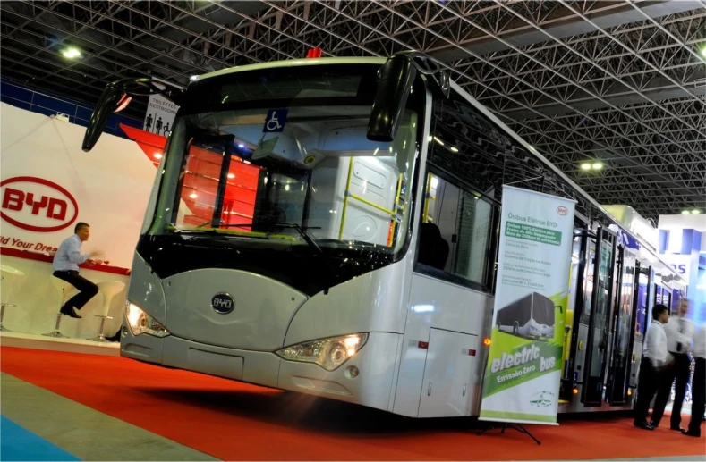 a man walking next to an open passenger bus