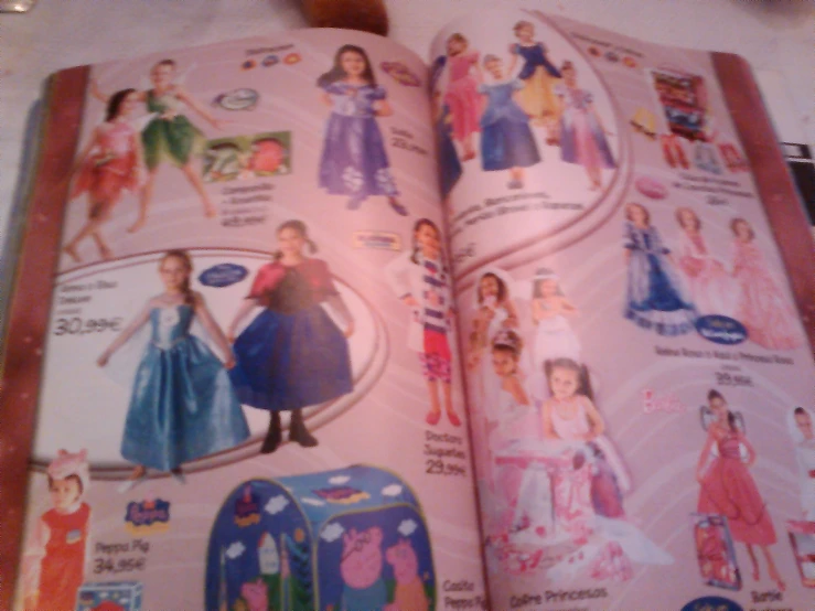 an open children's book with images of princesses on it