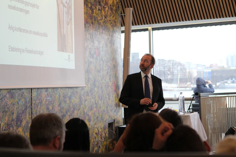 a man is giving a presentation to a group of people