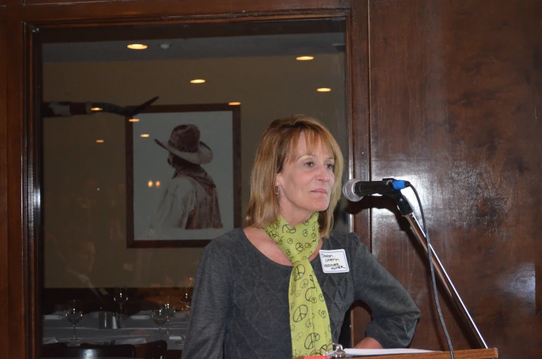 the woman is standing behind a podium at a conference