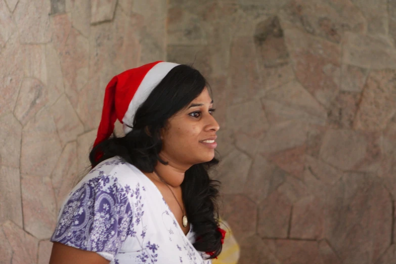 a woman with a santa hat looking at the camera