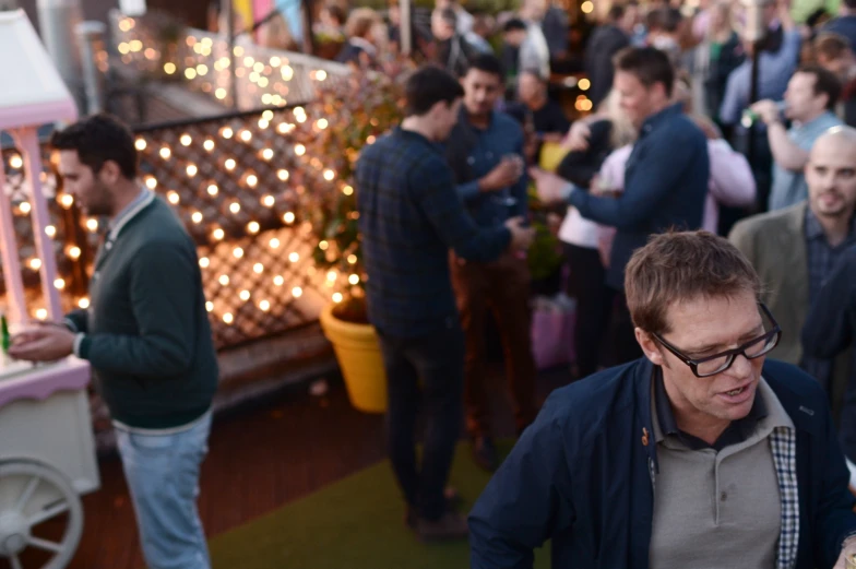 several people gather at a party and some have drinks in the cups