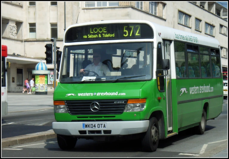 a green bus that has people on it