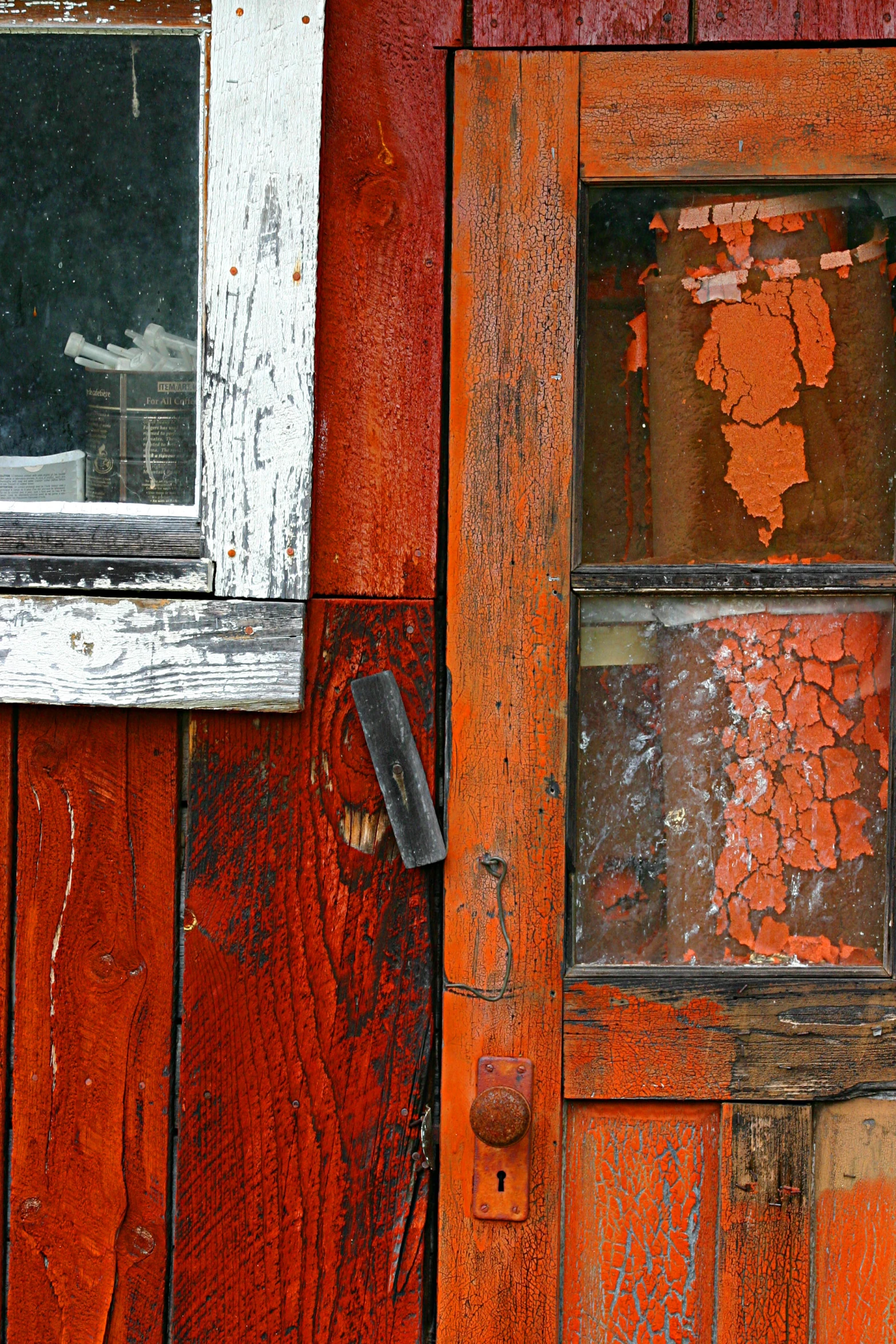 the wood paneling is peeling and chipping away from the window