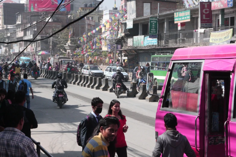 a street filled with people walking and riding bicycles