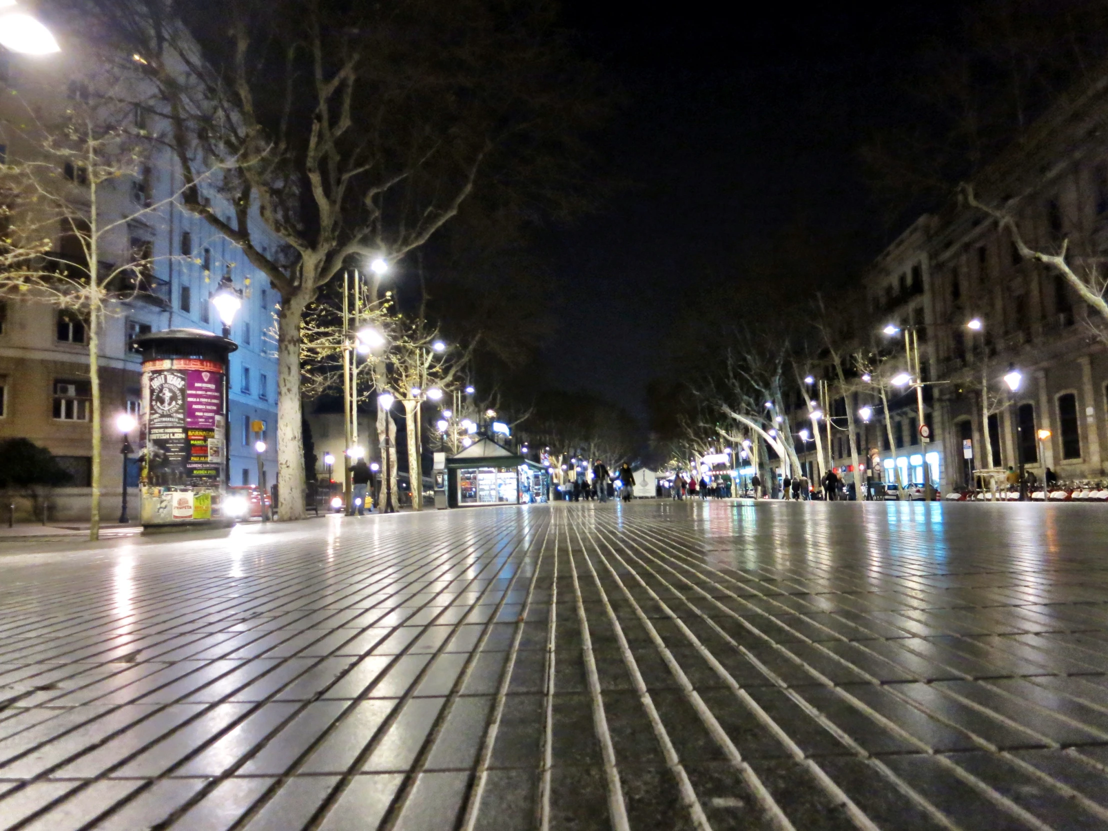 a street with several buildings on the side and one of them lined up