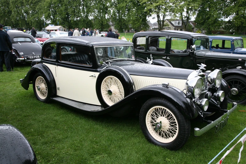 two vintage rolls royces parked next to other vintage rolls royce cars