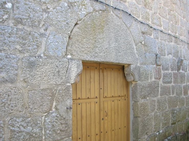 the door to a large stone building is shown