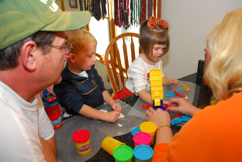 a group of children are playing at the table