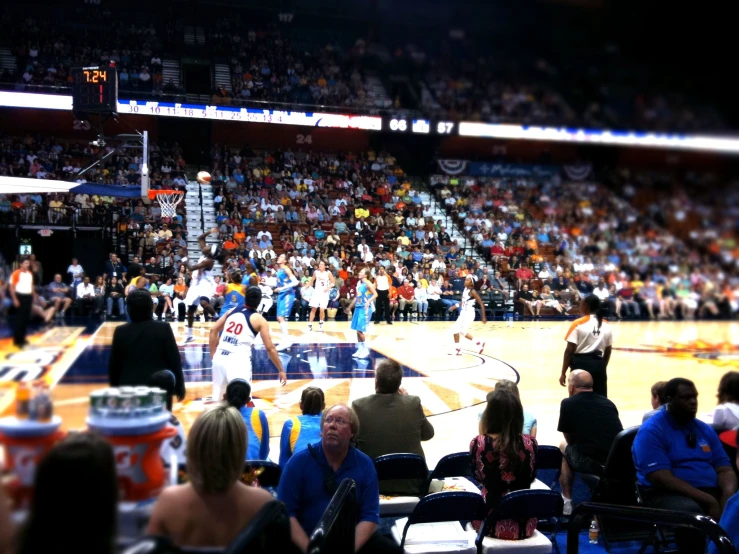 a crowd watching a basketball game in an arena