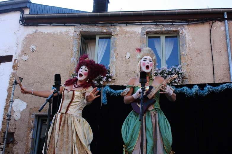 two ladies performing in a carnival outside