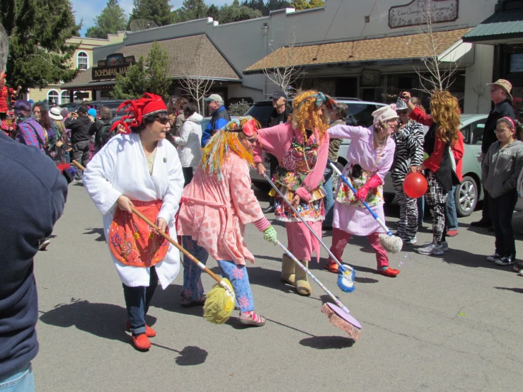 several people dressed up with colorful clown costumes