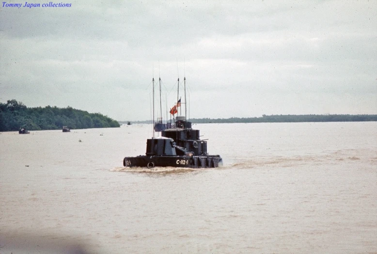 the boat is out on the water near a forest