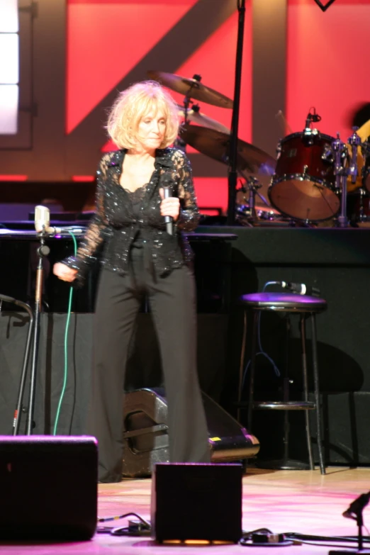 a woman on stage speaking to an audience