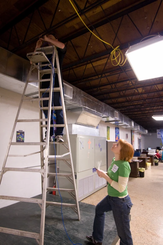 the girl is climbing up and down the ladder