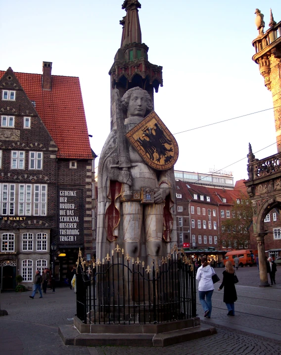 a statue is sitting in the middle of a town square