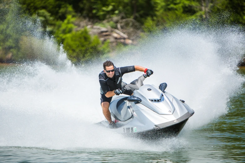 a man on a jet ski rides through the water