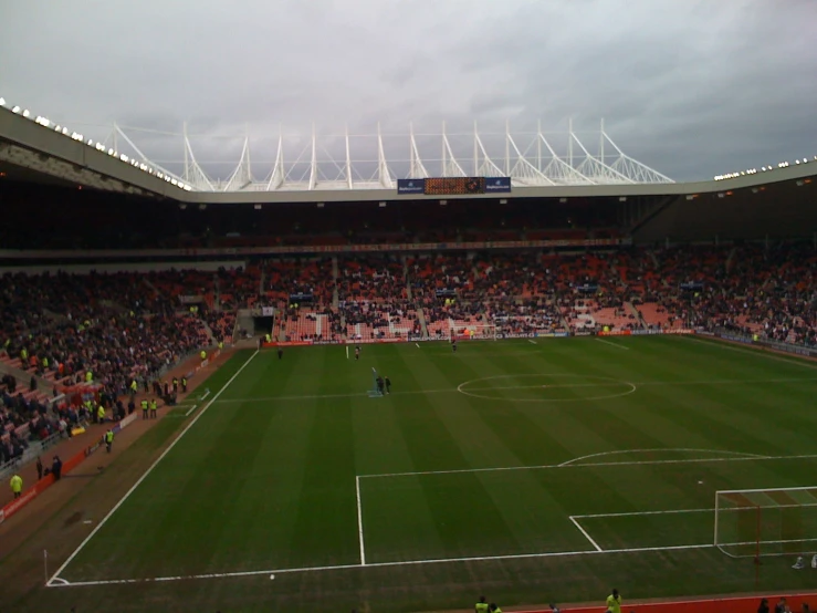 fans standing in an empty stadium watching the action