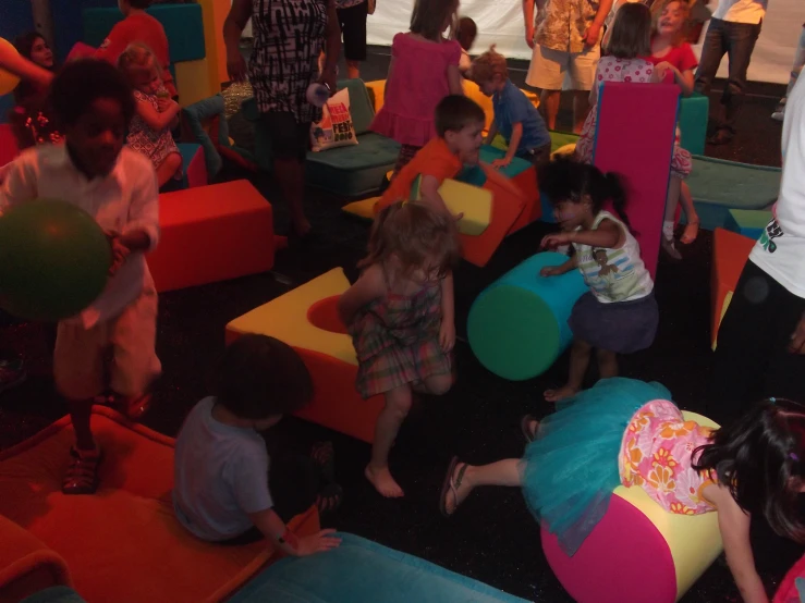 young children are gathered in the children's playroom