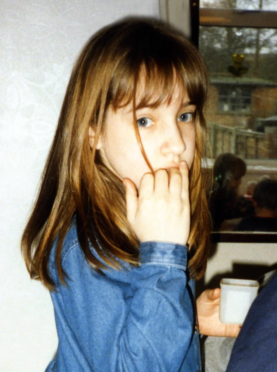 a young child is sitting down drinking coffee