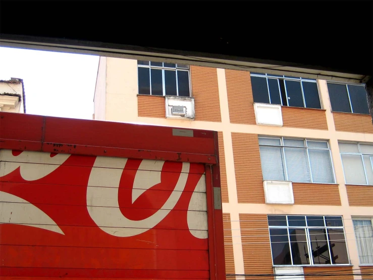 an old coke advertit is painted on the side of a building