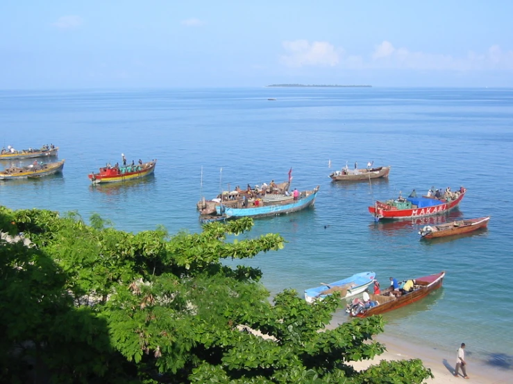 a group of boats floating on top of a large body of water