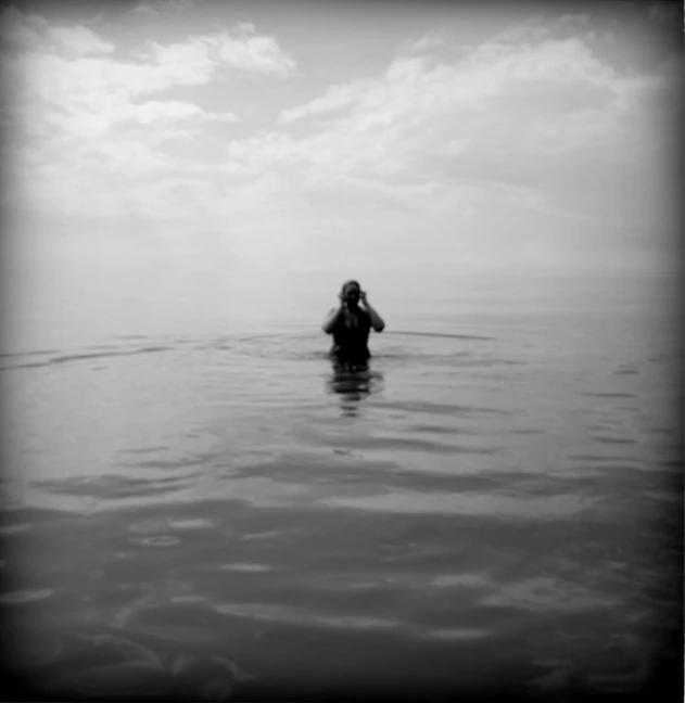 black and white pograph of someone in the ocean