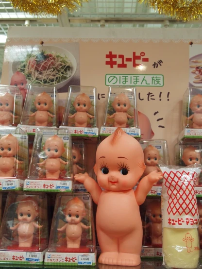 a display of little asian dolls is posed in front of a background