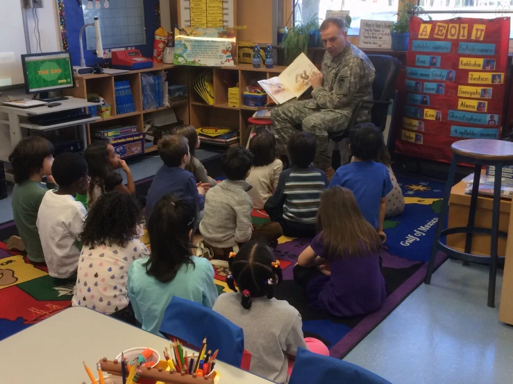 an instructor reads to children in a classroom