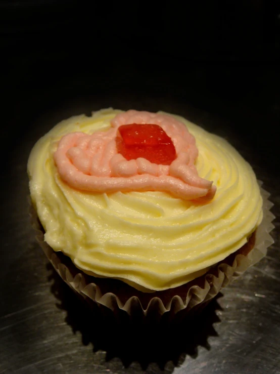 a cupcake with lemon cream, raspberry filling and a jelly